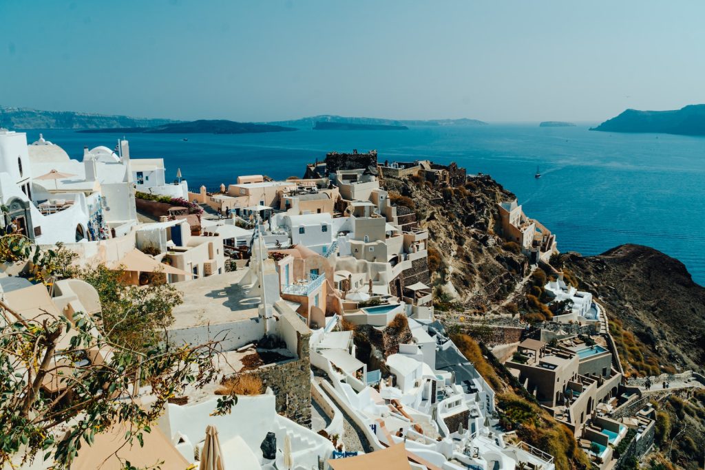 a view of a village on a cliff overlooking the ocean