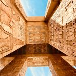 low angle photography of brown concrete building under blue sky during daytime