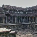 a large building with a pool in front of it