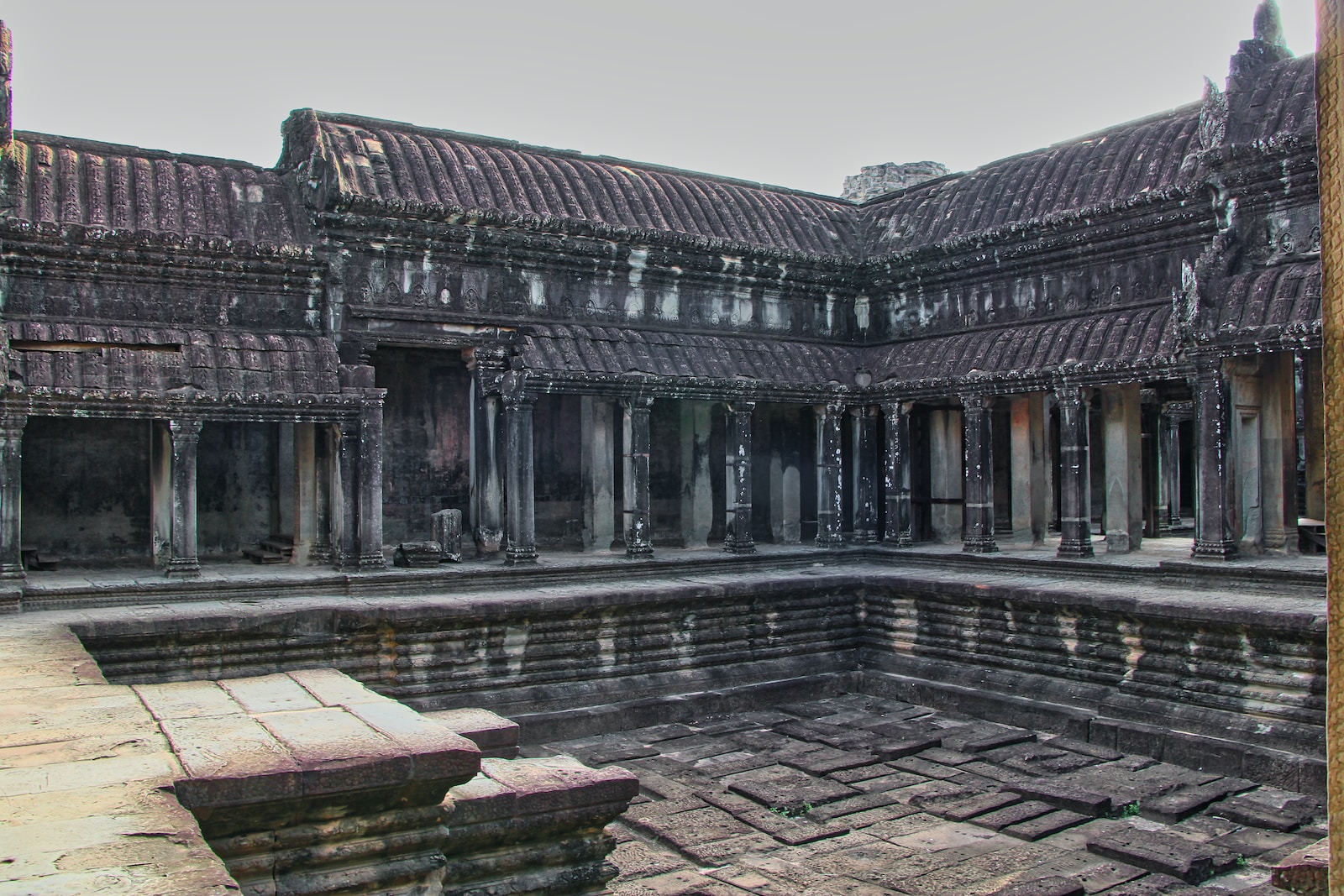 a large building with a pool in front of it